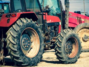 red tractor on gray sand during daytime